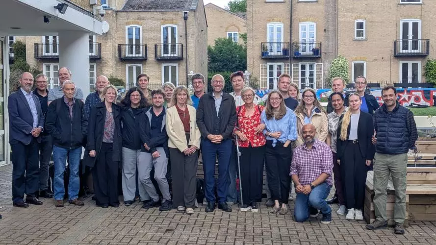 Group photo of the PAINSTORM consortium. About 30 people stand by a London canal, facing the camera, on a sadly not very sunny day.