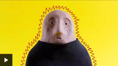 A clay figure in a black t-shirt on a yellow background, surrounded by a spiky red line