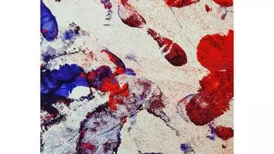 Overlapping footprints and ink spots in blue and red